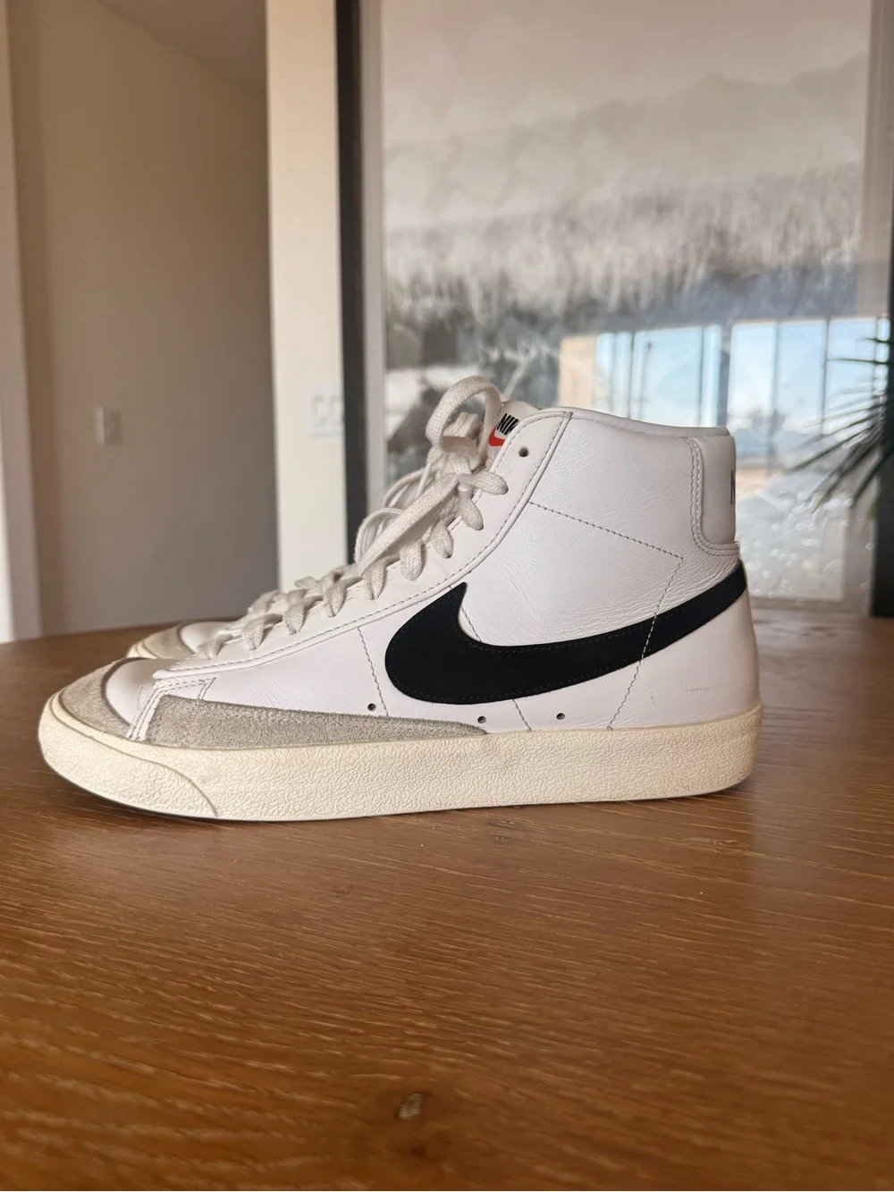 Nike White High-Top Sneakers with Black Swoosh